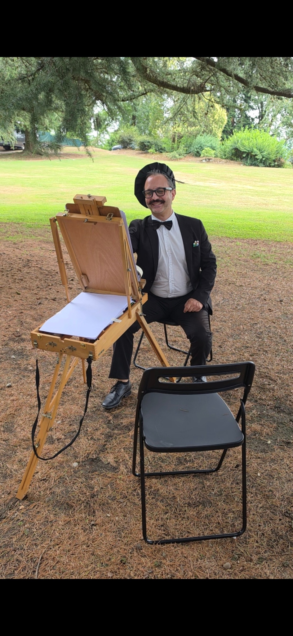 Gli sposi davanti alla parete di caricature realizzate da Yatri